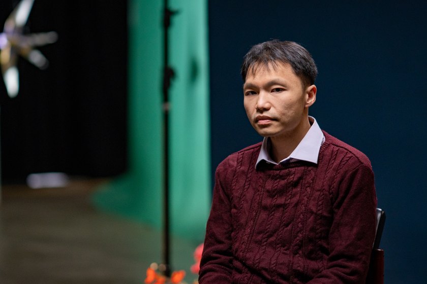 Dr Eric Hadinata seated against a dark blue background